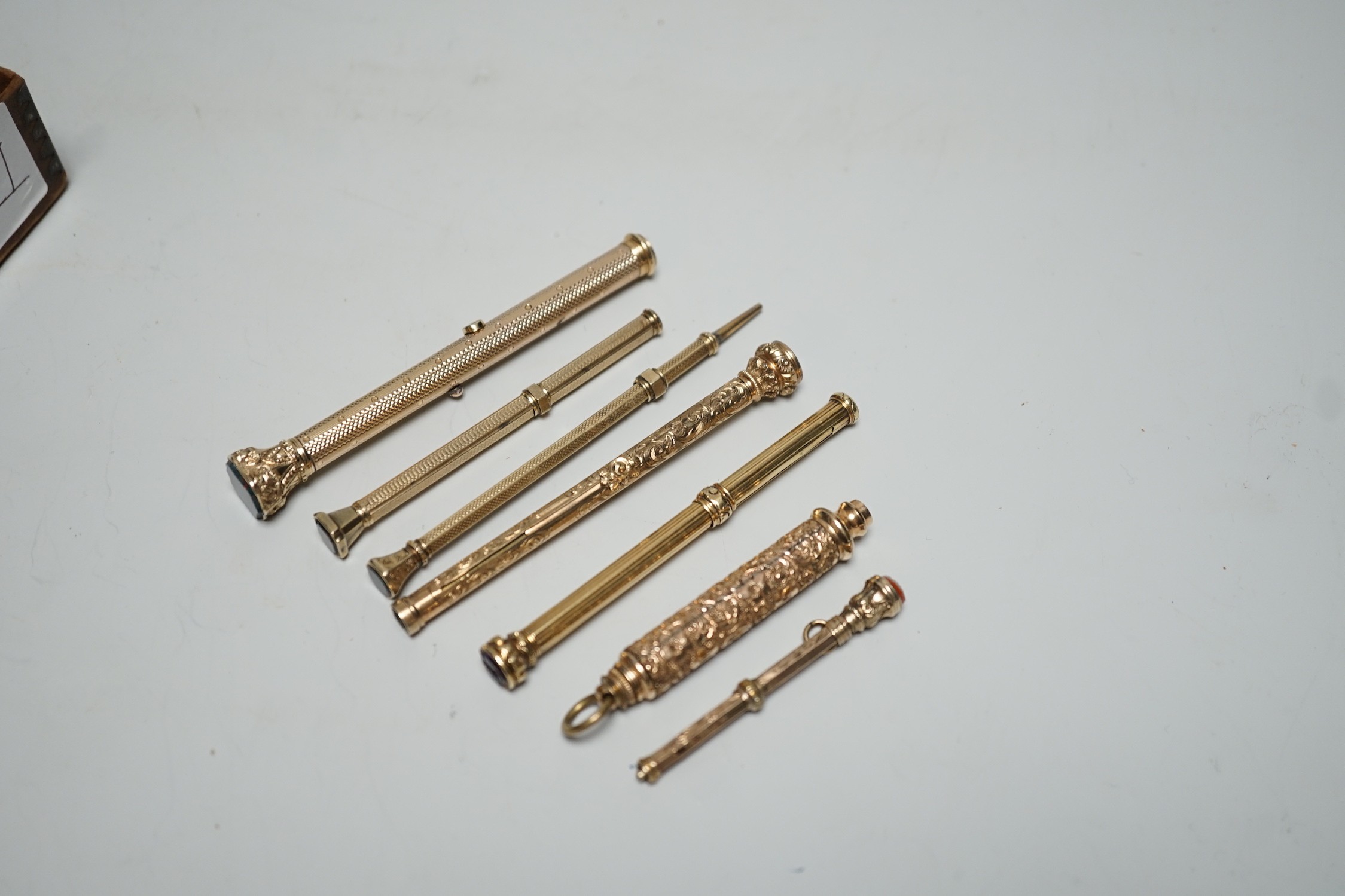 Seven assorted yellow metal overlaid and gem set propelling pencils